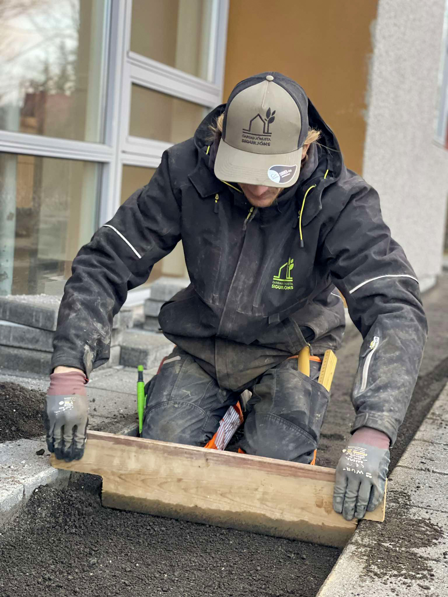 Undirlag þjappað með vibroplötu til að tryggja stöðugleika undir hellulögn.